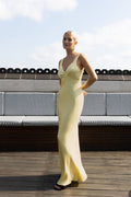 Long satin yellow slip dress on model front view