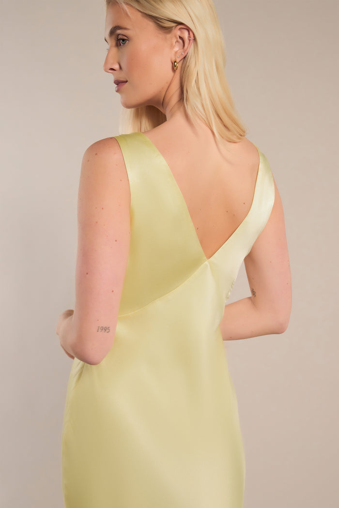 Low v back butter yellow bridesmaid dress on blonde model