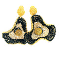Black and gold flower statement earrings with an oversized floral shape and intricate beaded detail.