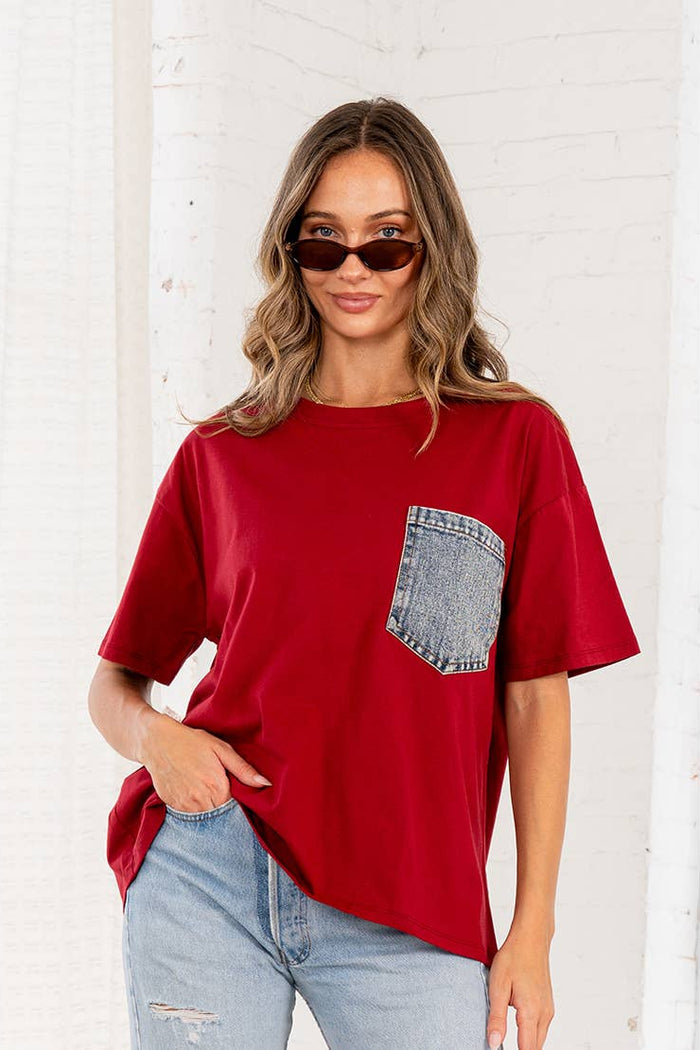 Burgundy oversized half sleeve top with dropped shoulders and a contrasting denim front pocket.