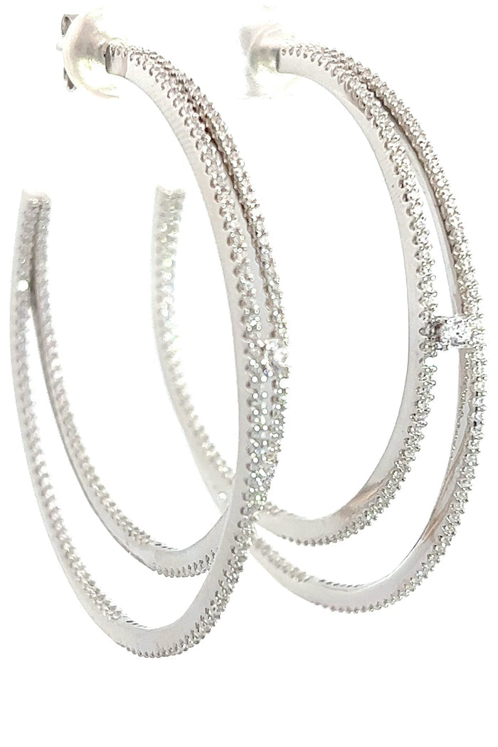 Sterling silver double hoop earrings with intertwined open hoops accented by white cubic zirconia crystals.