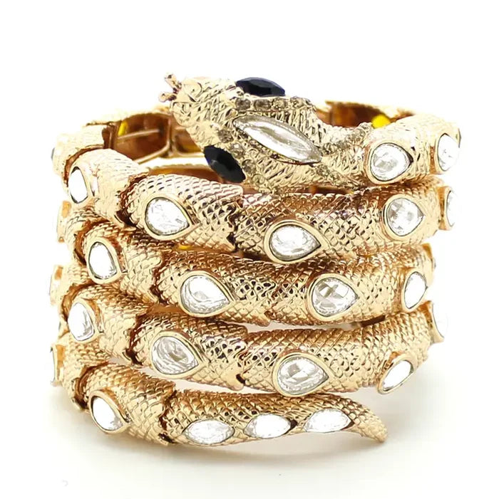 Gold-tone coiled snake statement bracelet with textured scales and sparkling crystal accents.