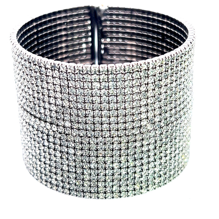 Wide dark silver crystal statement cuff bracelet with sparkling embellishment and a structured oversized silhouette.