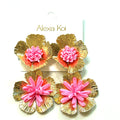 Pink and gold oversized flower statement earrings with textured metallic petals and three-dimensional floral detail.