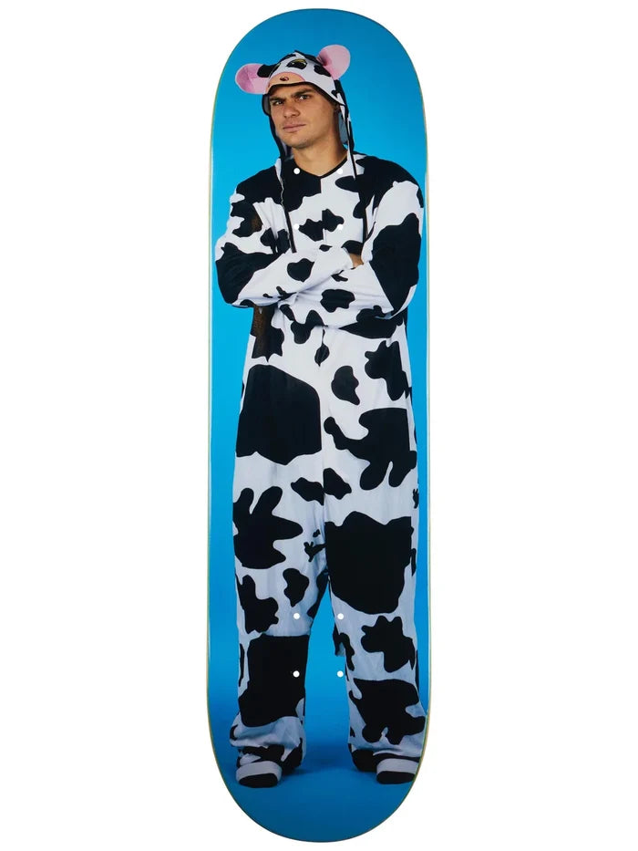 Person wearing a cow onesie standing on a blue skateboard deck