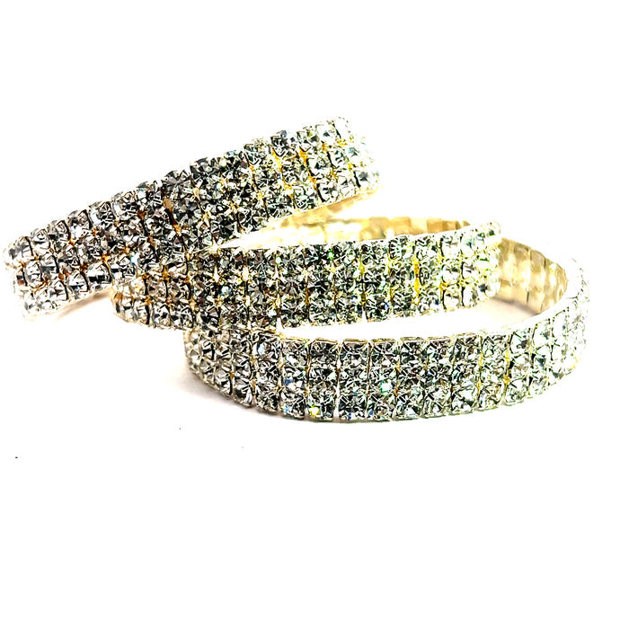 Rhinestone cuff bracelet stack with three polished open bangles covered in sparkling crystal details.