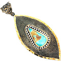 Turquoise leaf-shaped sterling silver pendant with a turquoise gemstone, rhinestone accent, and gold-finish border.