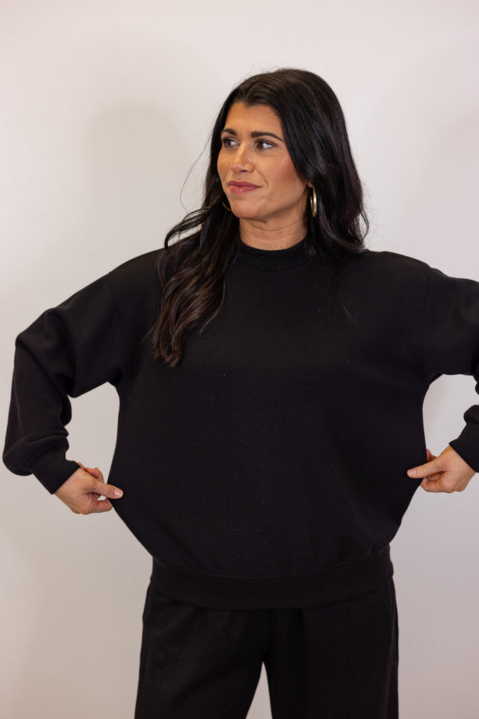 Black scuba knit mock neck pullover top by Rae Mode showing true to size fit